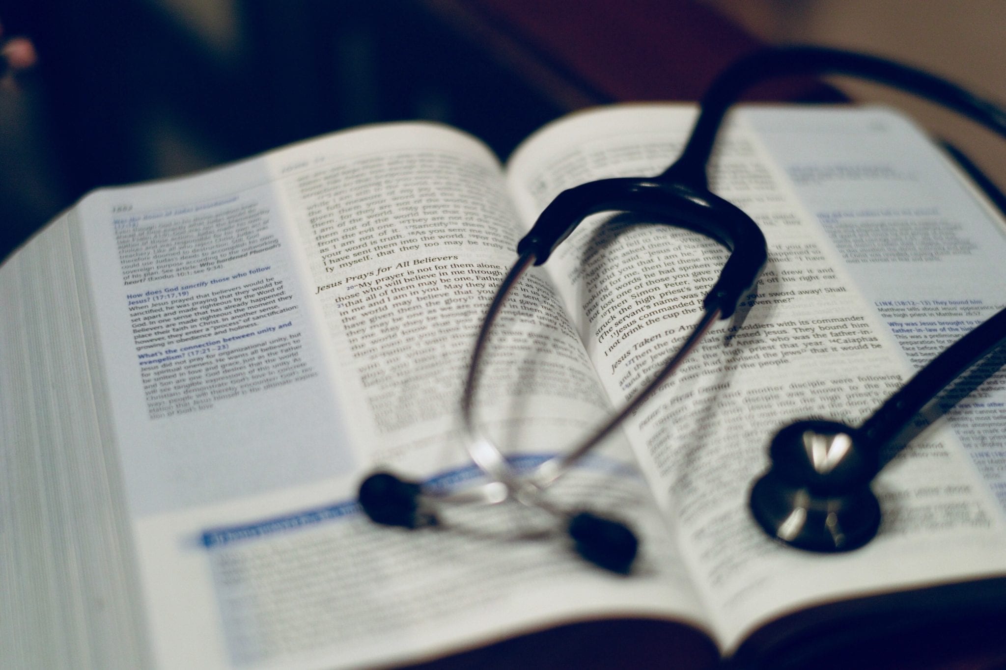 A stethoscope sits on a Bible.